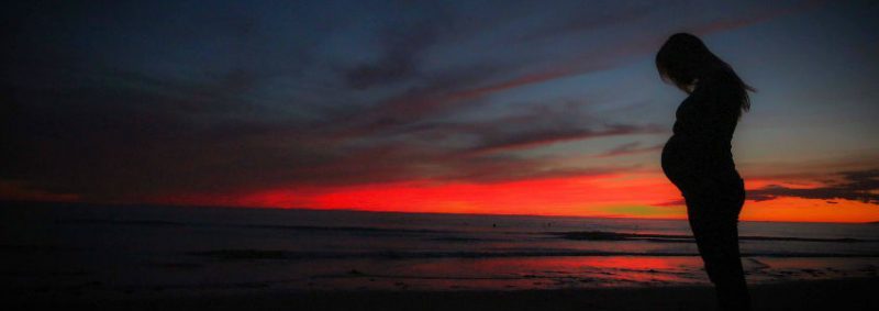 pregnant woman silhouette sunset